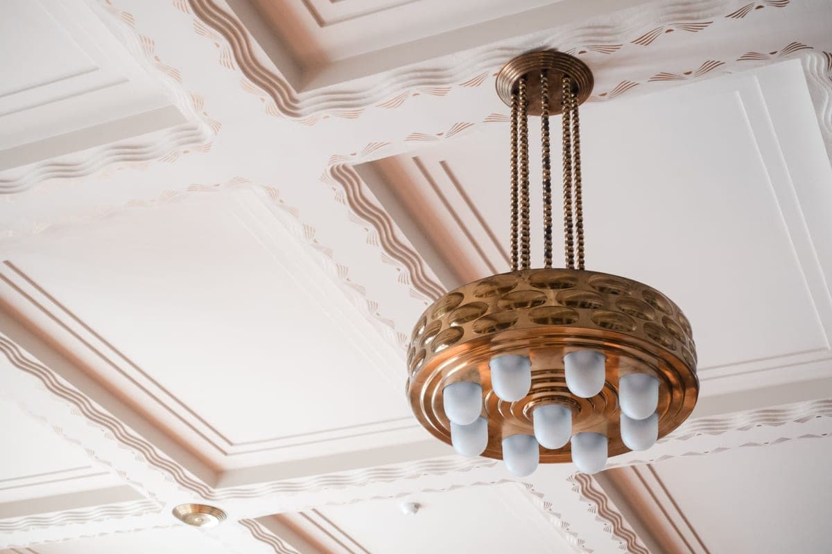 A geometric brass-toned interior detail with stepped forms and clean lines