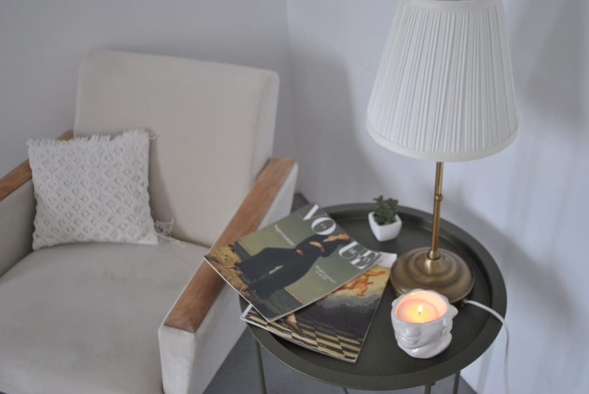 A compact corner of a room styled with a small piece of furniture and wall decor