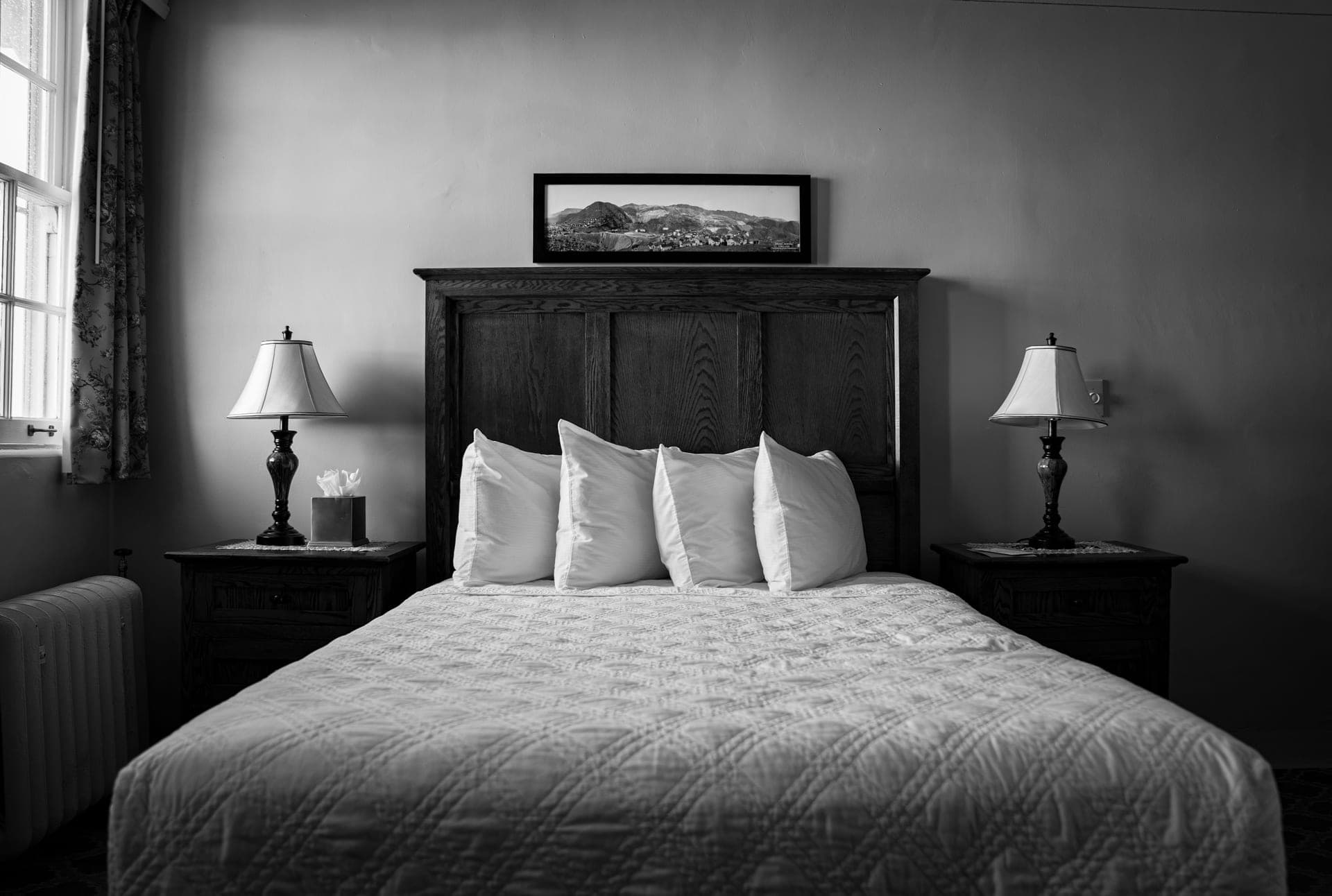 A decorated bedroom with classic furniture and soft lighting