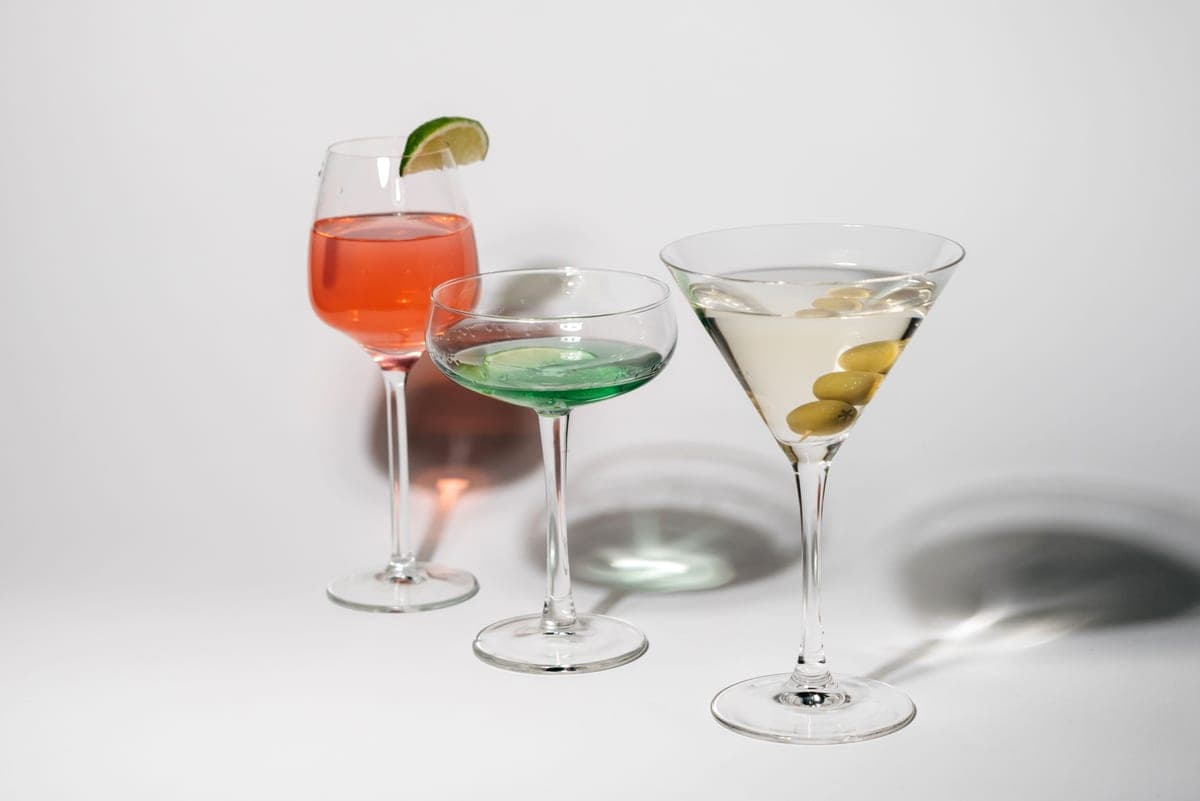 A coupe glass and a martini glass standing side by side