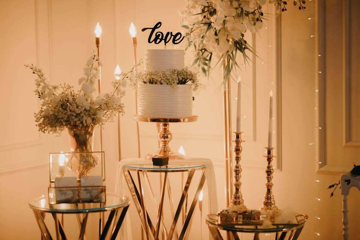 A two-tier gold trolley with clear glass shelves