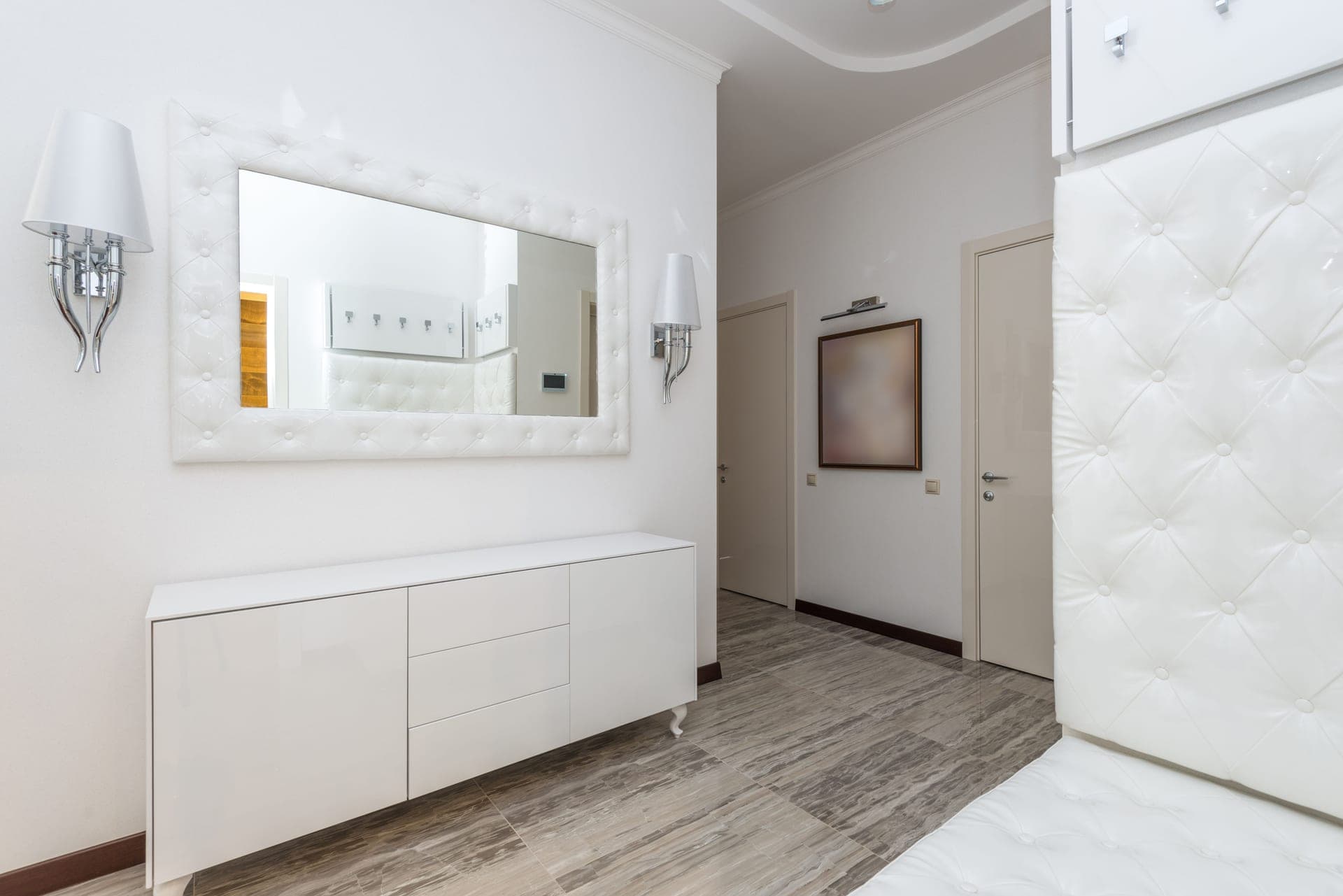 A modern interior with a large wall mirror and contemporary furniture