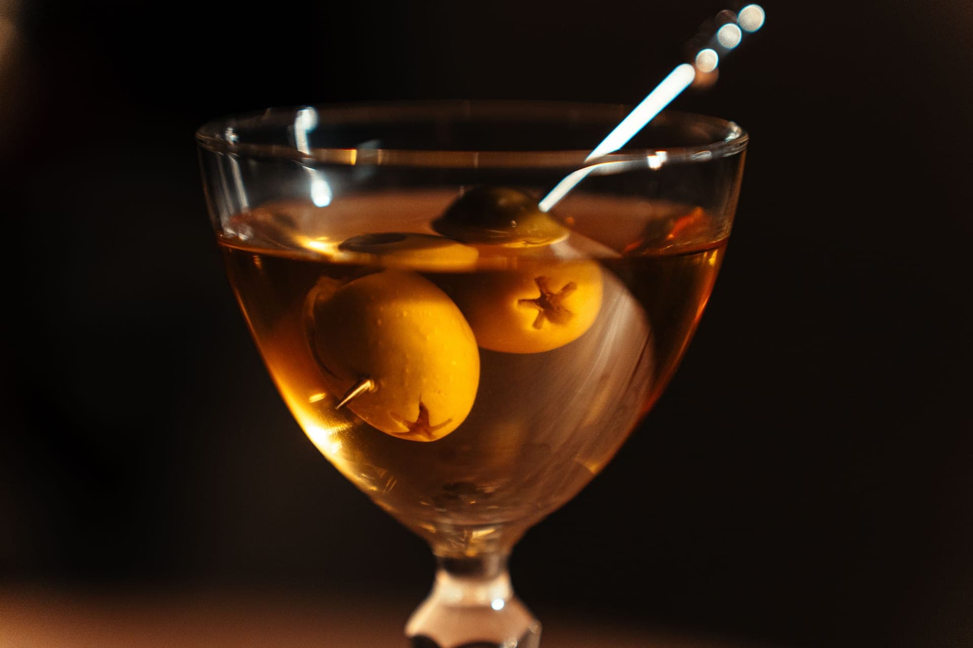 A classic martini with olives served in a cocktail bar