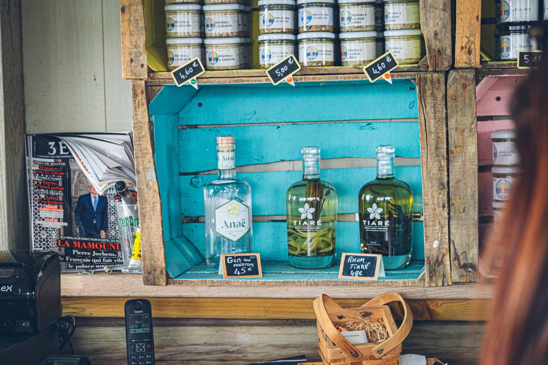 Spirit bottles displayed on a small rustic wooden shelf