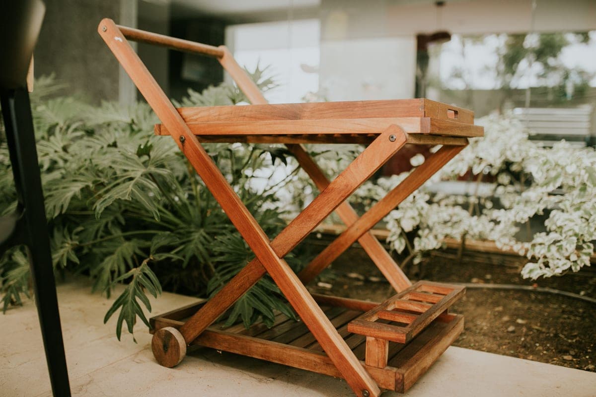 Three serving carts of different heights lined up against a studio wall
