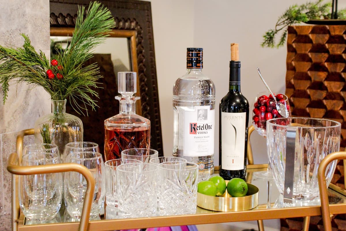 A brass-framed cart with glass shelves photographed side-on in soft daylight